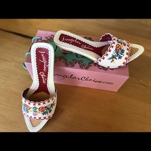 Cute low heel white sandal with embroidered top.